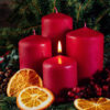 Red candles in advent wreath decoration on wooden dark background Adventskranz aus Nordmanntanne